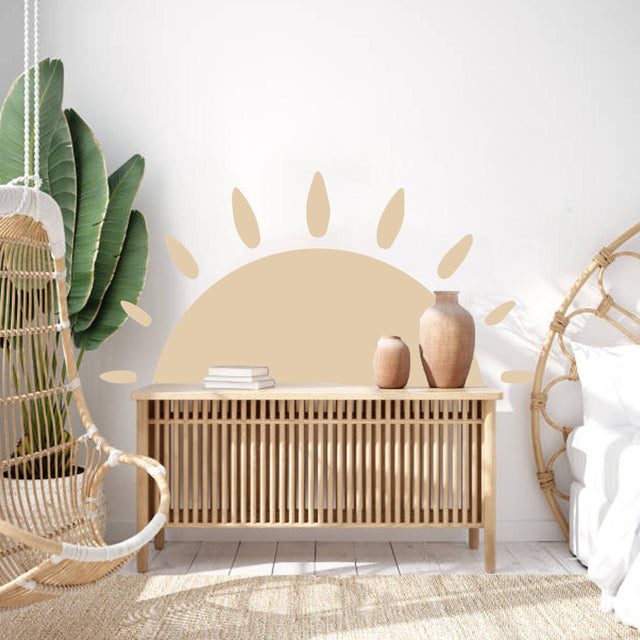 Boho sun vinyl wall decal in a bright room with a wooden storage unit and plant, perfect for interior design.