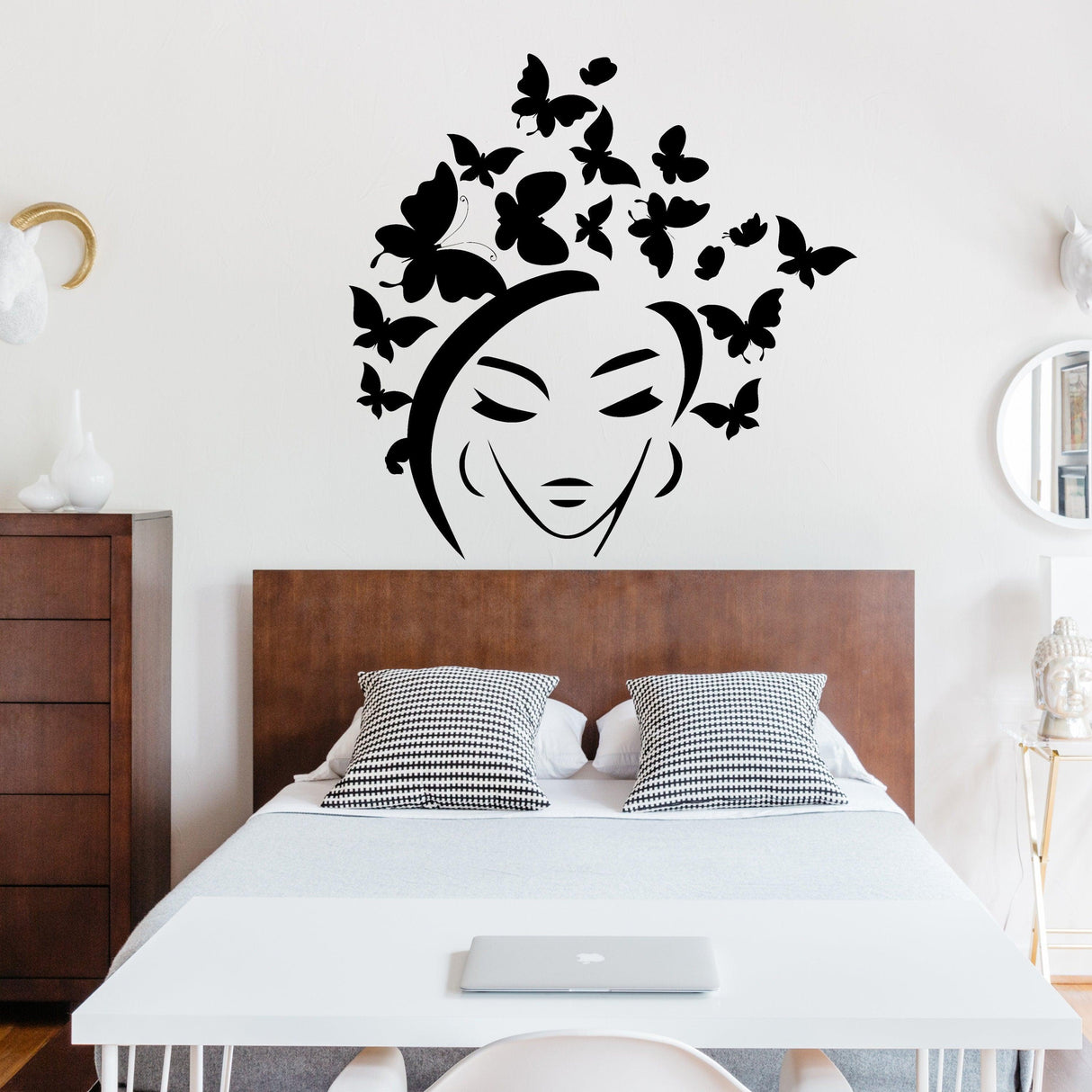 Butterflies hair wall decal featuring a stylish butterfly head design above a modern bed in a cozy room.