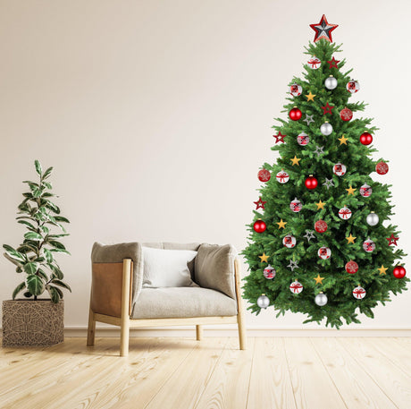 Large Christmas tree wall vinyl decal with ornaments in a cozy living room setting.