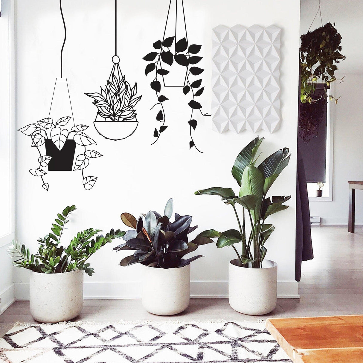 Tropical hanging plant basket wall sticker decor in modern living room with potted plants and geometric wall art.