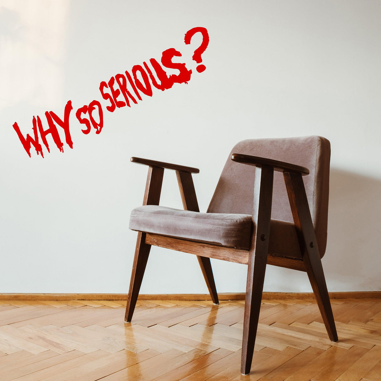 Why So Serious? vinyl wall sticker above a stylish chair in a modern room setting.