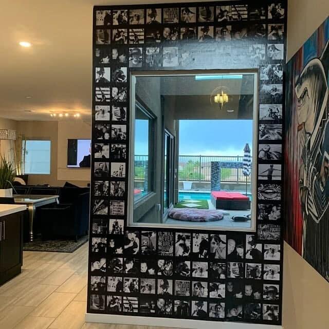 Custom wall art featuring a collage of black and white photos surrounding a large window.
