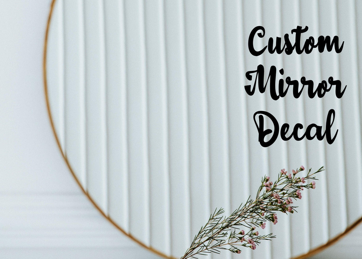 Custom mirror decal on a decorative round mirror with a floral accent, perfect for personalized home decor.