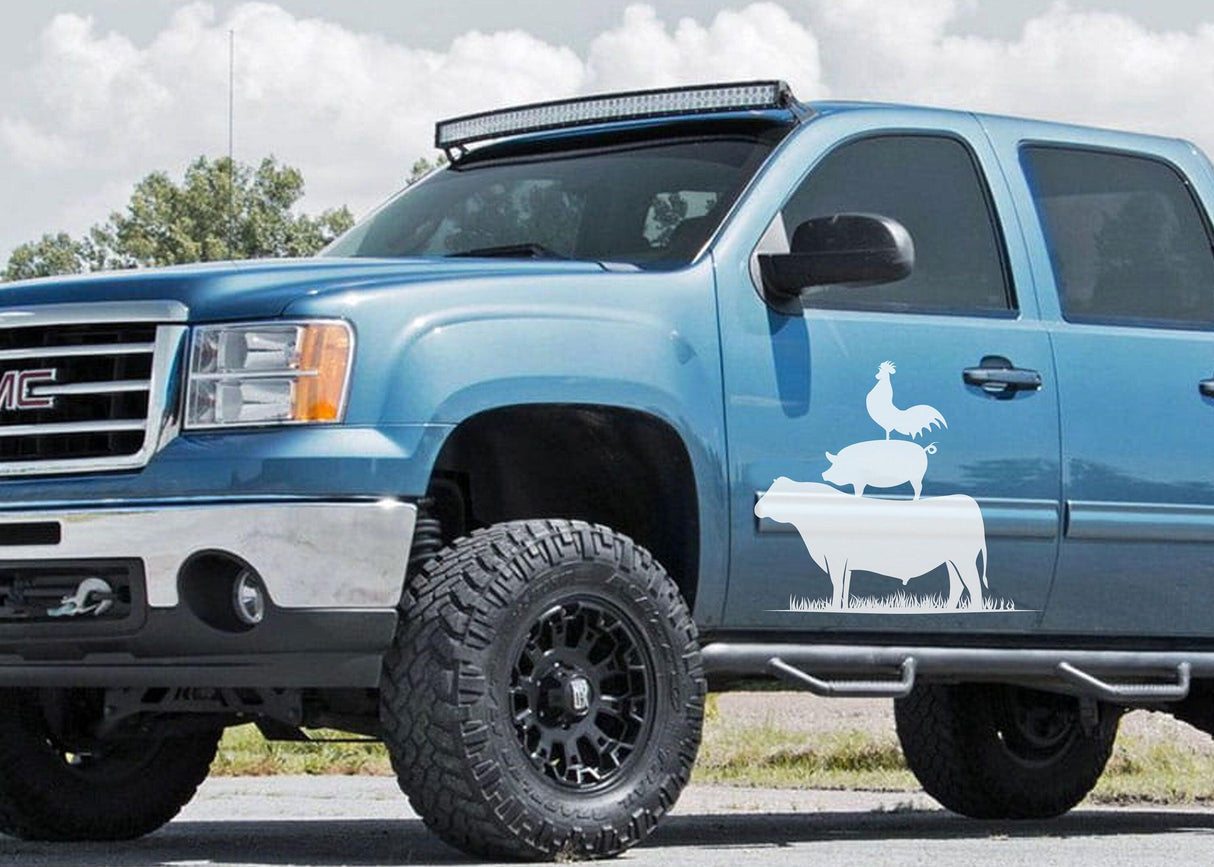 Blue truck with farm animal decals featuring a pig, cow, and chicken, showcasing rustic charm and farmhouse style.