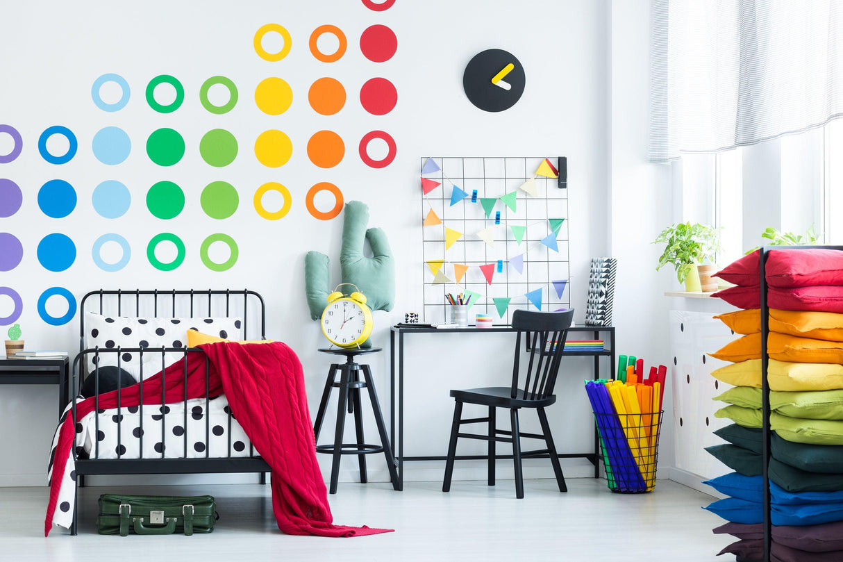 Colorful room decor featuring 36 rainbow circle wall decals, modern furniture, and vibrant pillows for a playful atmosphere.