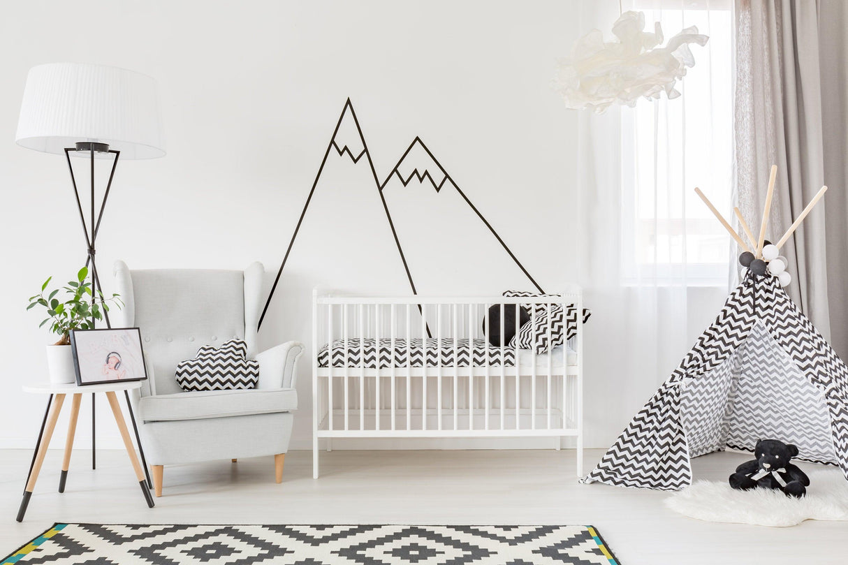 Cozy nursery featuring Black Mountain Line Peel and Stick Decals on the wall, with a crib and decor elements.