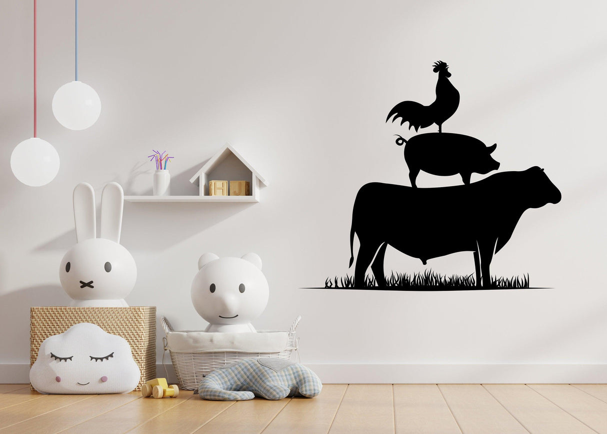 Silhouette wall sticker of a rooster, pig, and cow on a wall in a child's room, adding farm charm to decor.