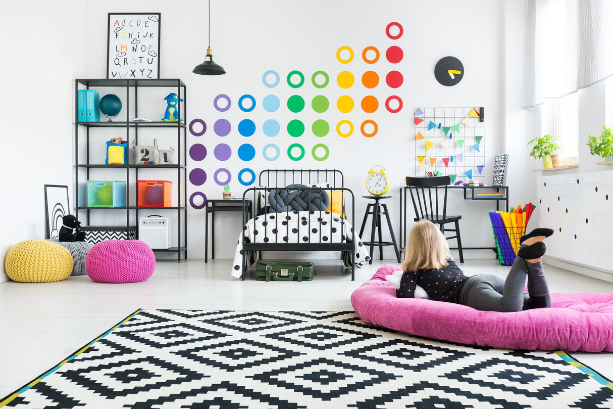 Colorful children's room with rainbow circle wall decals, modern furniture, and a playful atmosphere.