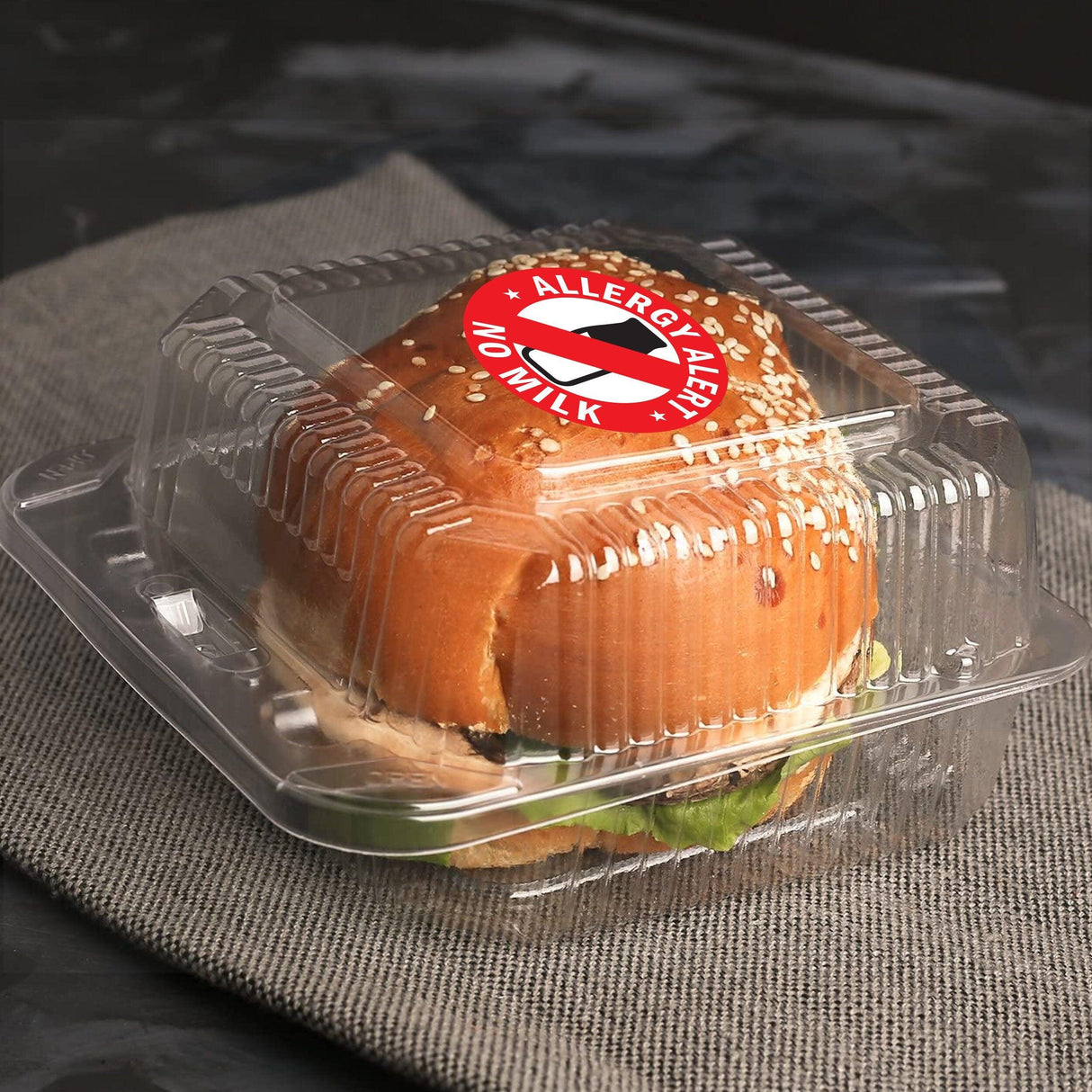 Clear food container with a 'No Milk Allergy' sticker on a sandwich, highlighting food allergy awareness.