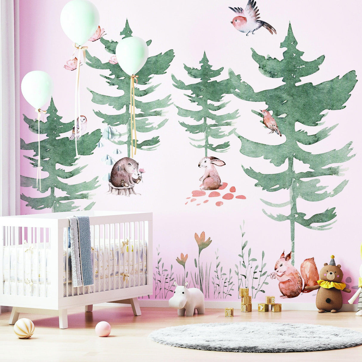 Whimsical woodland wall decal featuring forest animals and trees in a child's nursery with pastel colors and balloons.