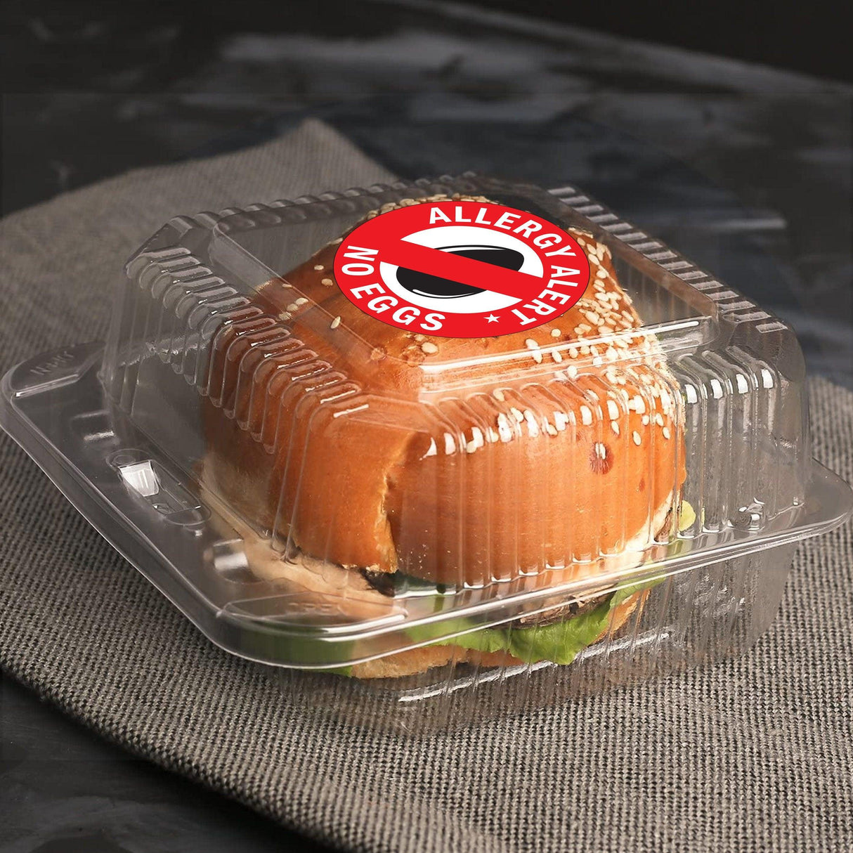 Sandwich in clear container with No Eggs Allergy Alert sticker for food allergy awareness and safety.