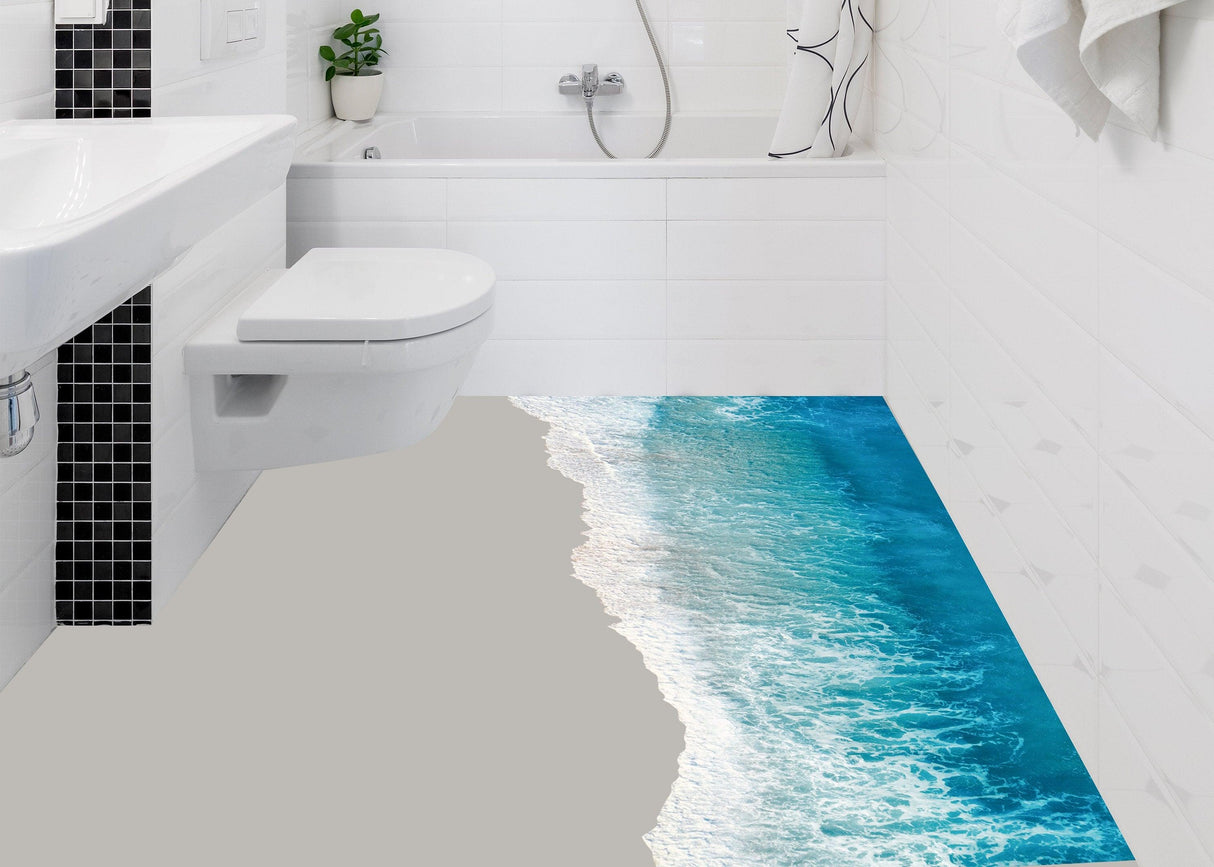 3D ocean beach floor sticker in a modern bathroom, creating a tropical oasis effect with stunning blue waves.