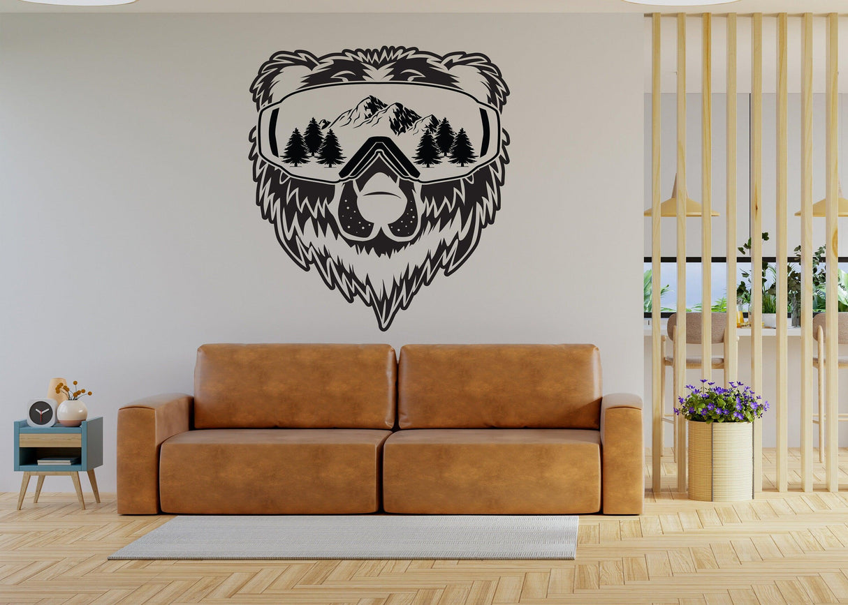 Vinyl wall decal of a bear with sunglasses, mountains, and trees in a cozy living room setting.