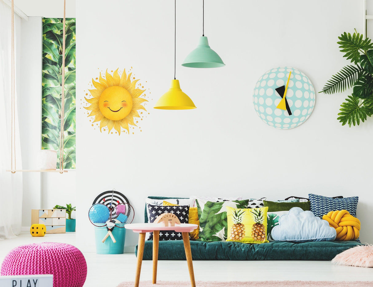 Cheerful nursery with Watercolor Happy Sun wall sticker, vibrant decor, and colorful cushions for a joyful child's room.