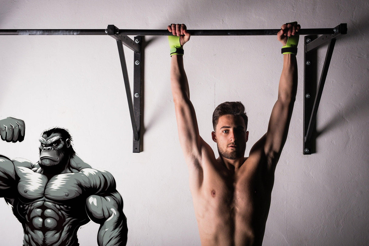 Man doing pull-ups under a muscled gorilla wall decal, showcasing fitness motivation and strength training.