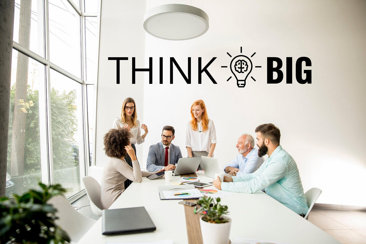 Motivational office meeting with 'Think Big' wall art sticker promoting inspiration and teamwork.