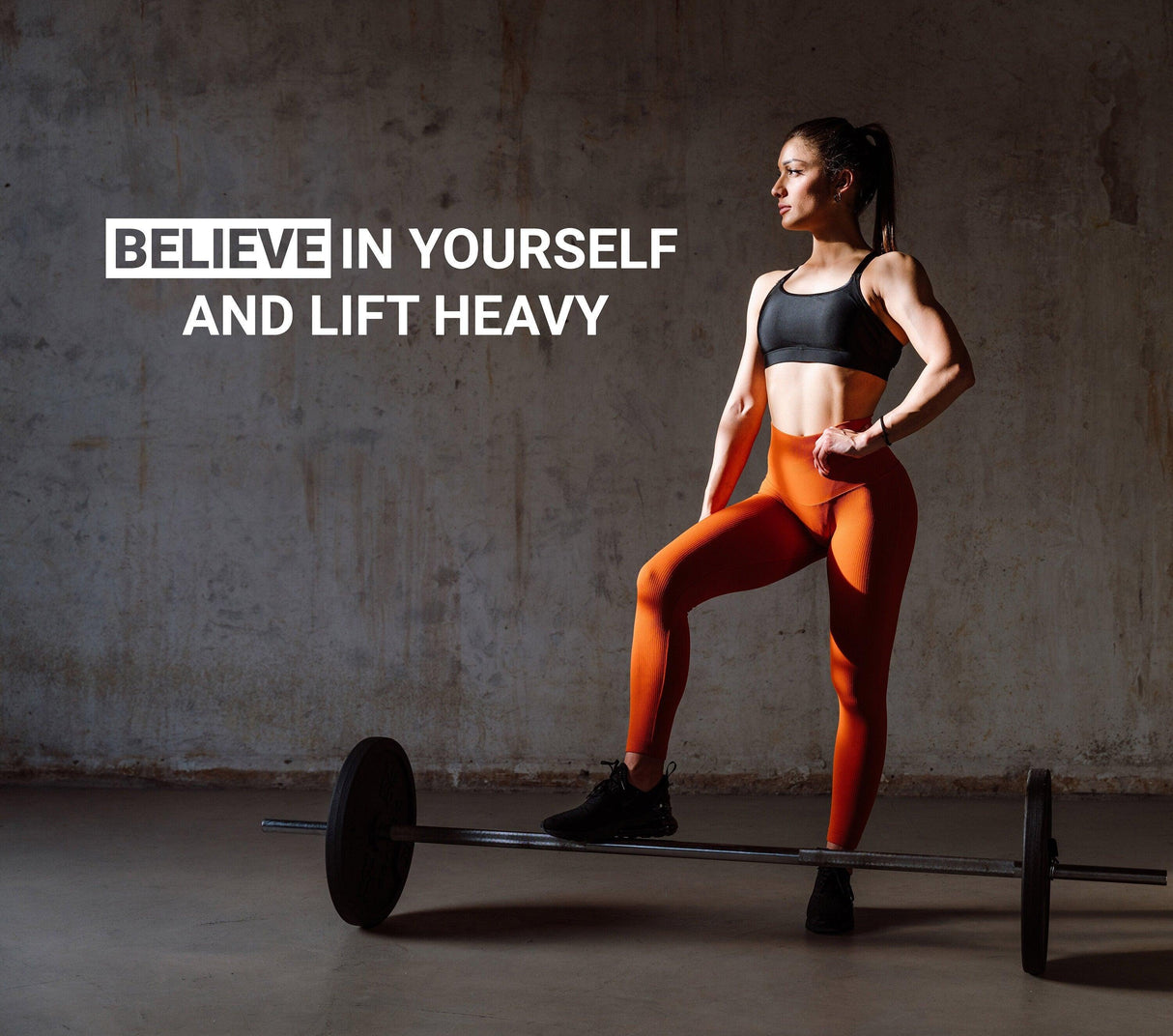 Motivational gym wall decal with inspirational quote 'Believe in Yourself and Lift Heavy', featuring a fit woman.