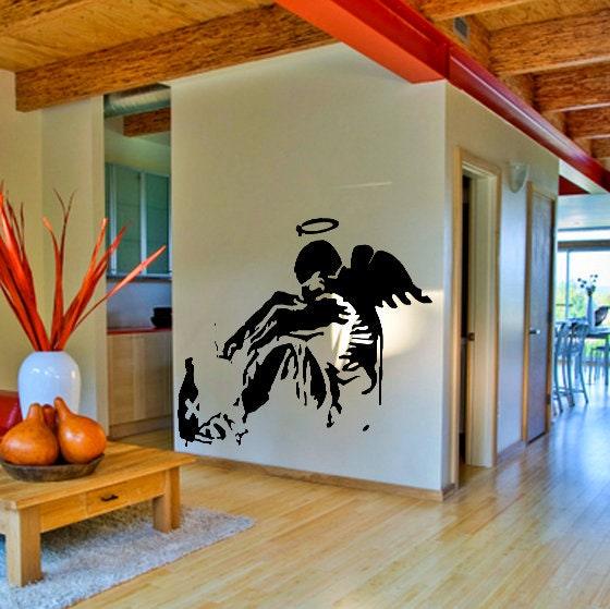 Banksy Fallen Angel wall sticker in a modern living room, featuring intricate wings and urban art.