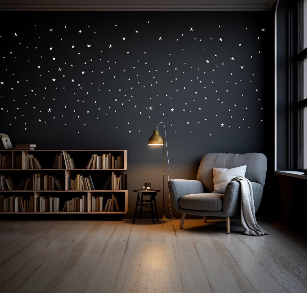 White stars wall vinyl stickers on a dark wall in a cozy living room with a reading chair and lamp.
