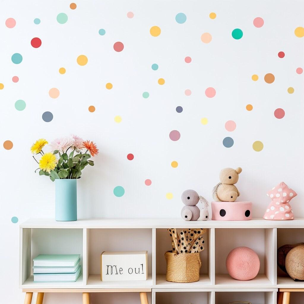 Colorful watercolor dot wall decals in a playful nursery with flowers and toys, perfect for kids' spaces.
