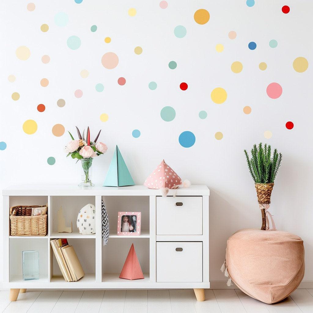 Playful watercolor round dot decals on a wall in a children's playroom, featuring colorful decor and furniture.