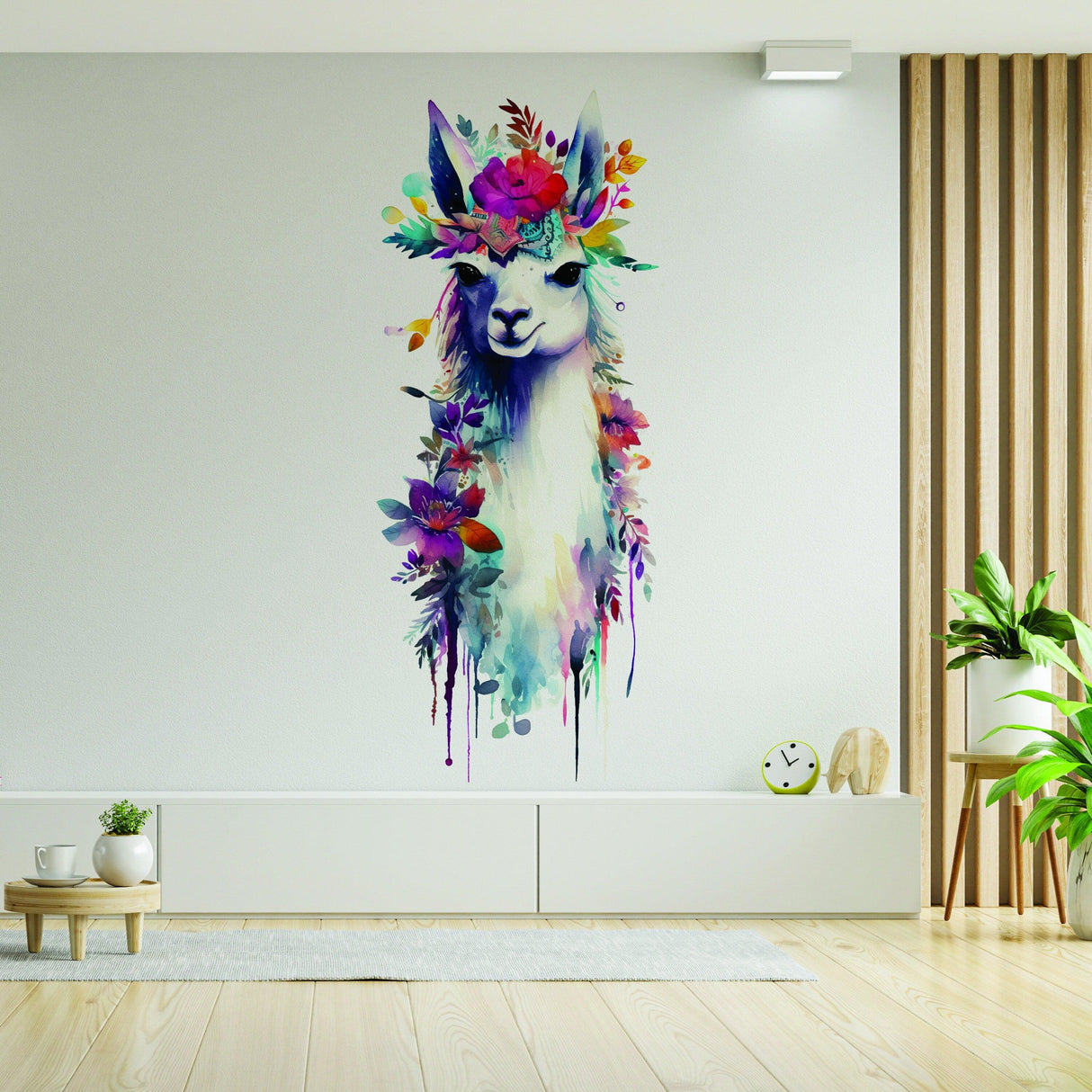 Artistic watercolor llama wall decal with floral crown in modern cozy interior setting.