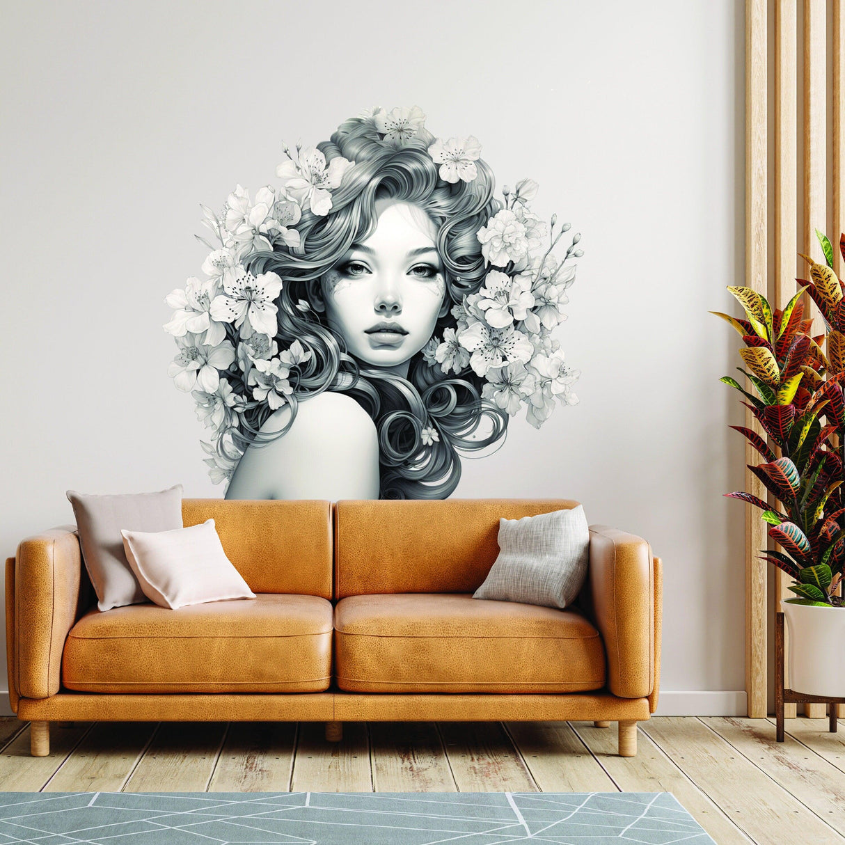 Elegant woman with floral design vinyl wall art above a cozy sofa in a modern living room.