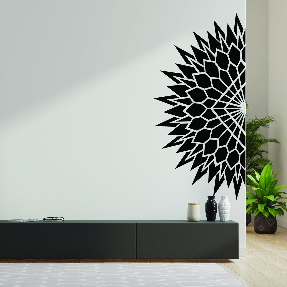 Half geometric mandala wall decal in black on a light wall, enhancing modern living room decor.