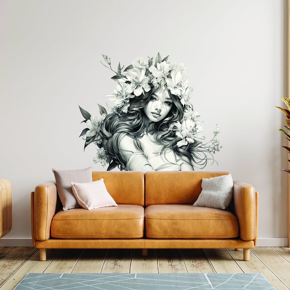 Elegant wall decal of a woman with floral hair above a cozy sofa, enhancing modern interior decor.