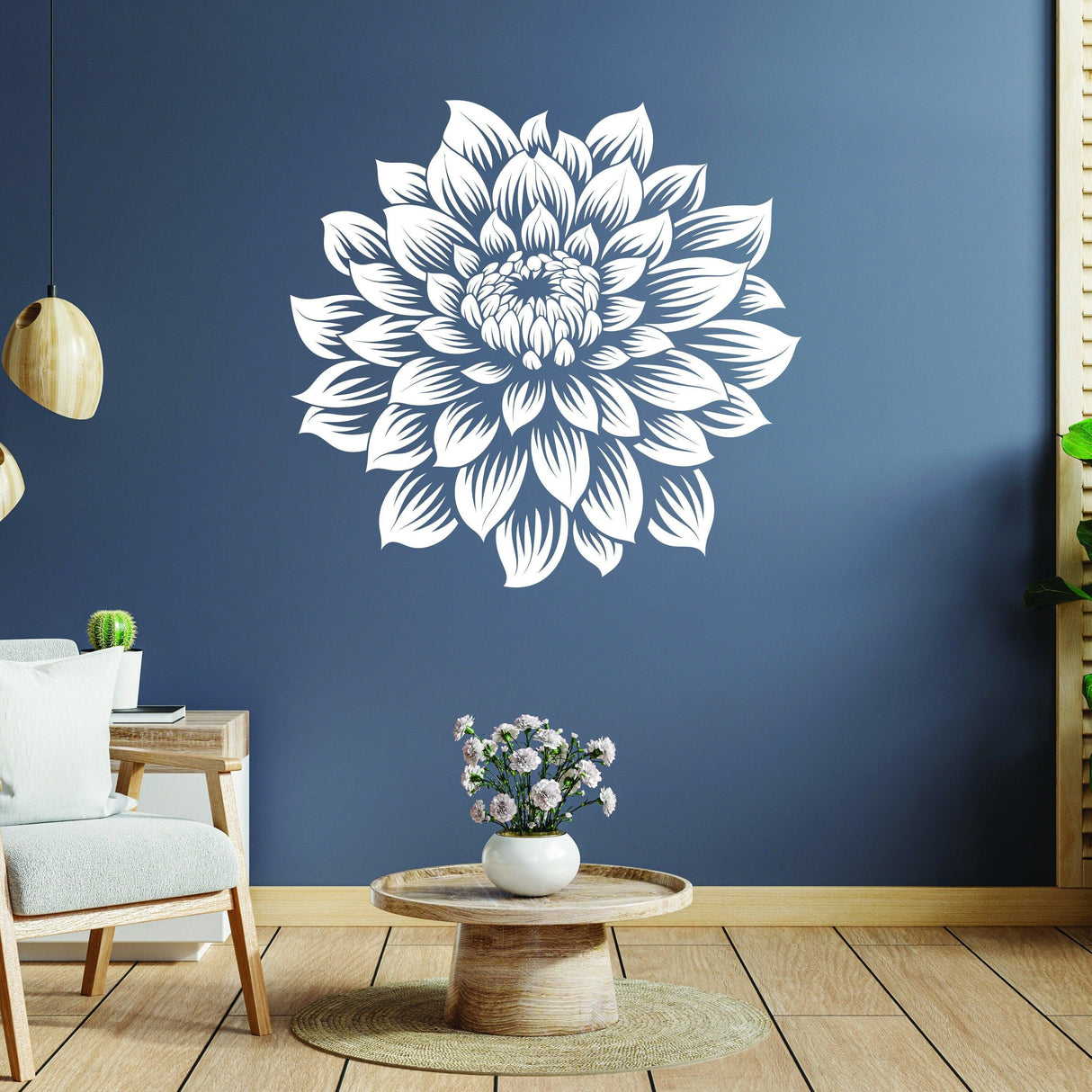 Large white flower wall decal on a blue wall in a stylish living room decor setting.
