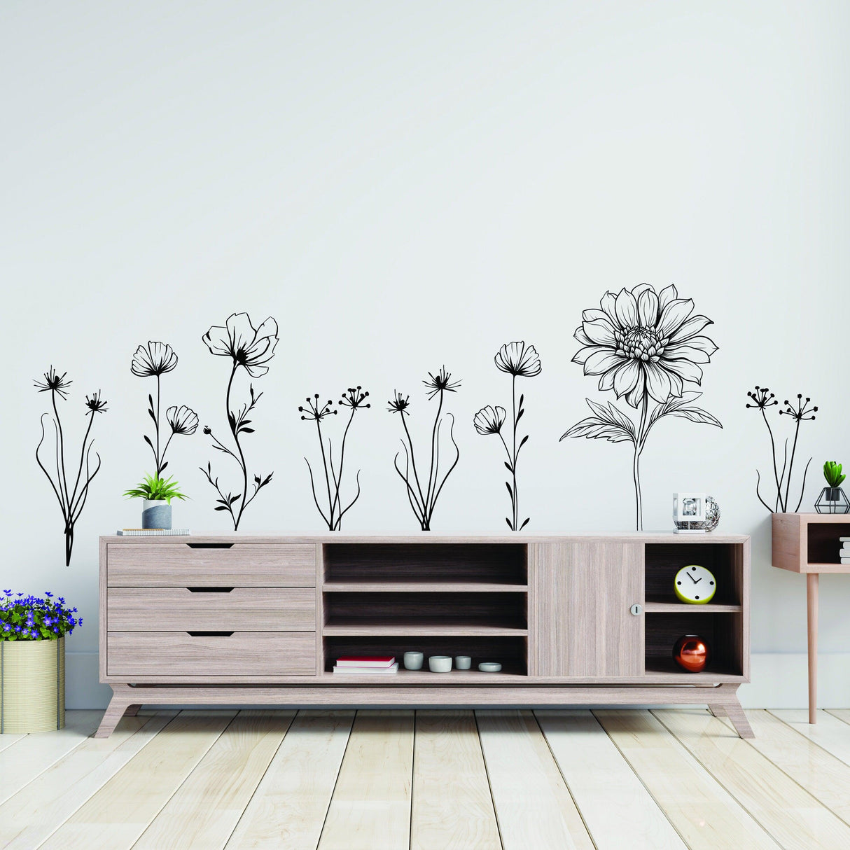 Elegant hand-sketched British wildflower wall stickers above a modern wooden sideboard.