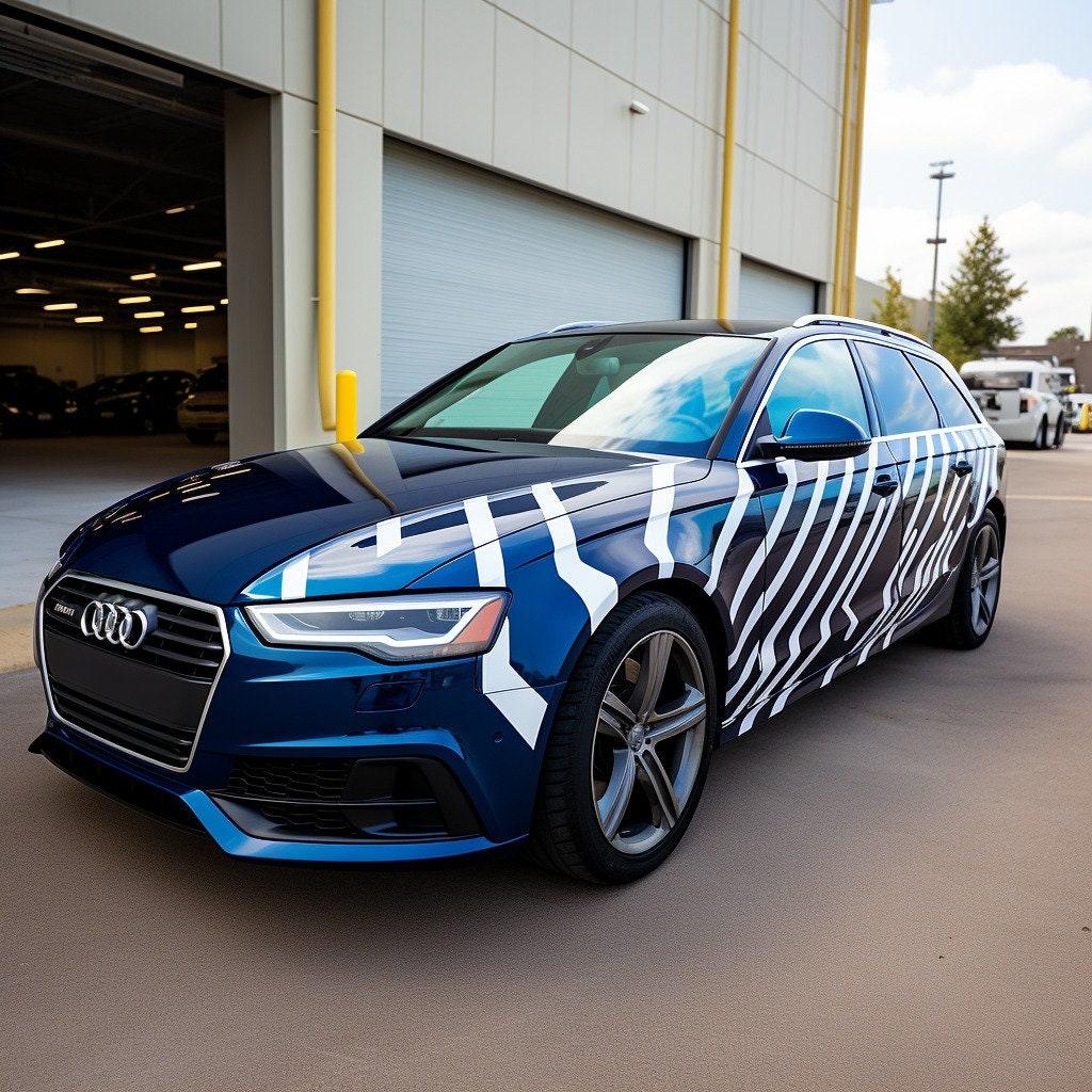 Audi car with geometric white vinyl stickers for a stylish automotive look in a garage setting.