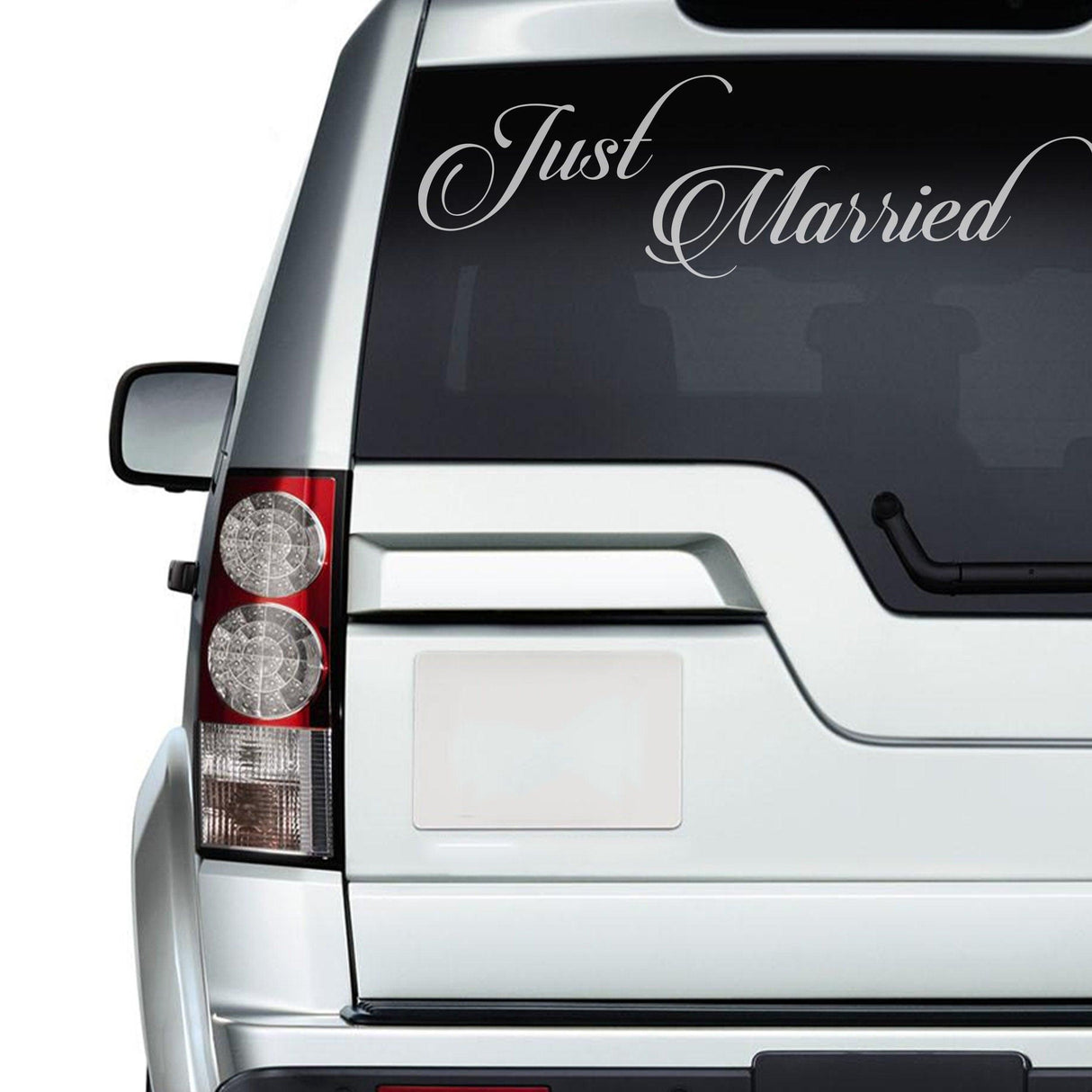 Just Married car decal on a silver vehicle's rear window, celebrating bridal bliss and newlywed joy.