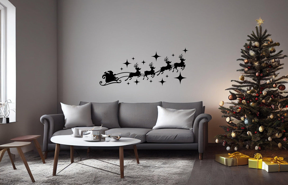 Santa sleigh and reindeer wall decal above a cozy sofa, enhancing festive Christmas home decor.
