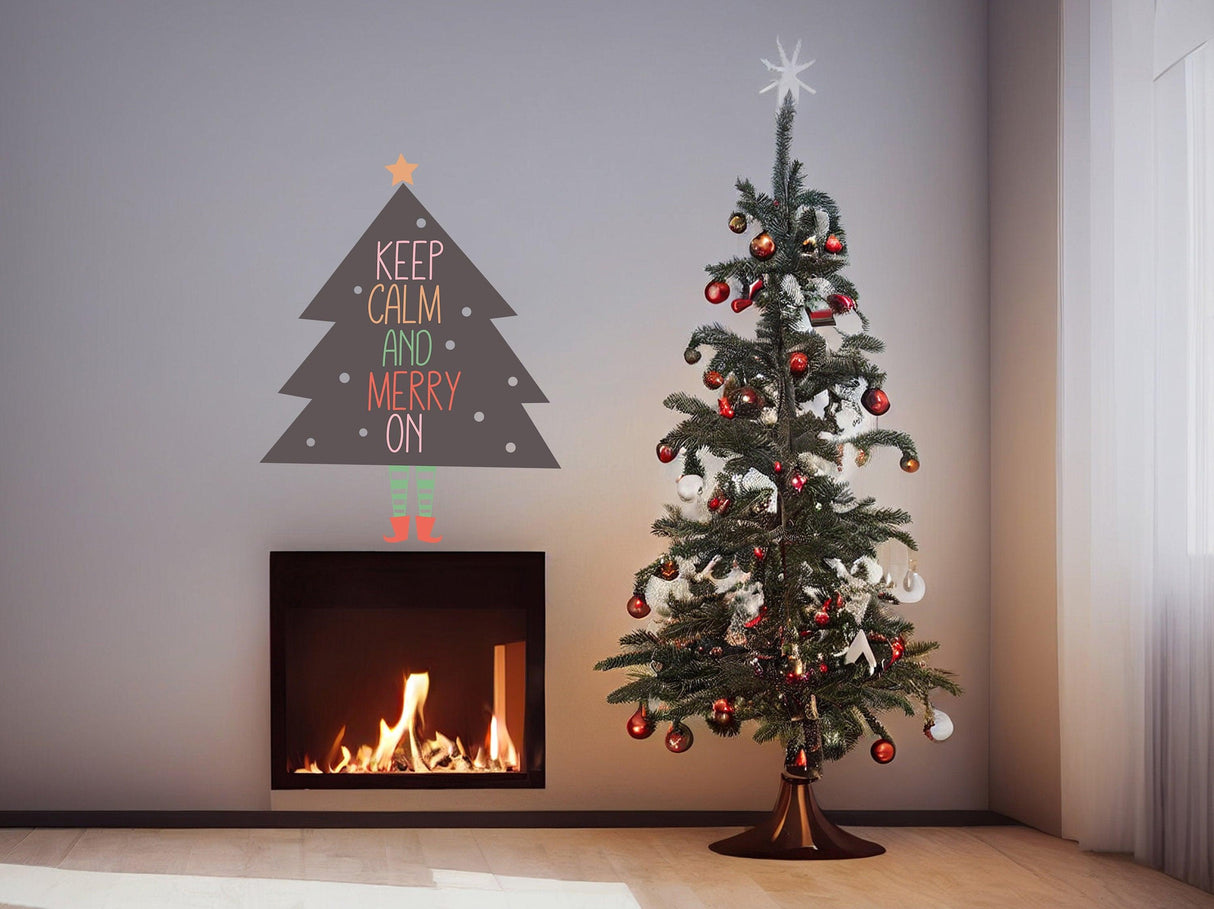 Whimsical Christmas tree with legs wall sticker saying 'Keep Calm and Merry On' beside a decorated tree and fireplace.