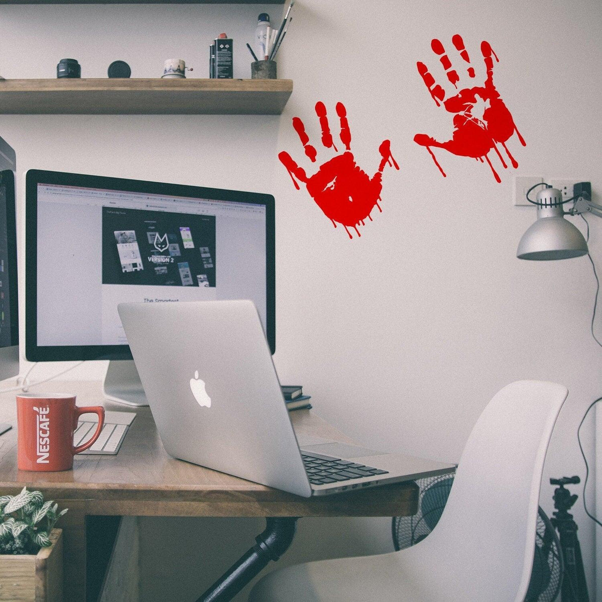 8-inch red bloody hands decal on wall above a desk with a laptop, perfect for Halloween decor.