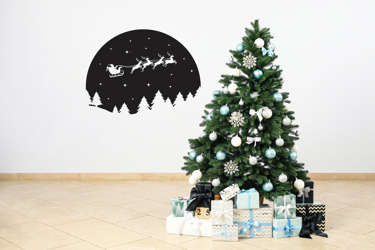 Starry Sky Santa and Sleigh wall decal above a decorated Christmas tree with gifts.