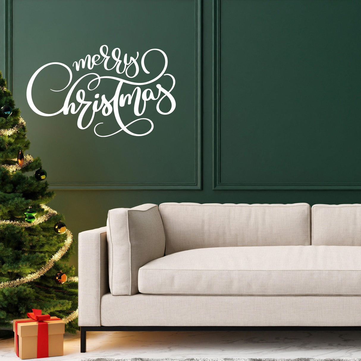 Elegant "Merry Christmas" wall vinyl sticker on green wall, festive living room decor with couch and Christmas tree.