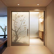 Frosted black cherry blossom tree silhouette decal on glass doors, adding elegance and privacy to modern interiors.
