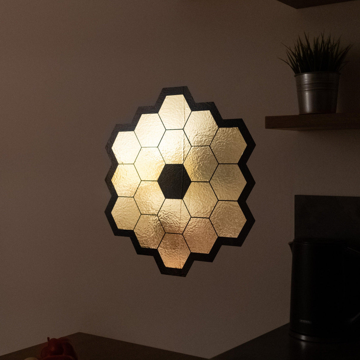 Gold chrome hexagonal mirror wall sticker resembling a space telescope, adding elegance to room decor.