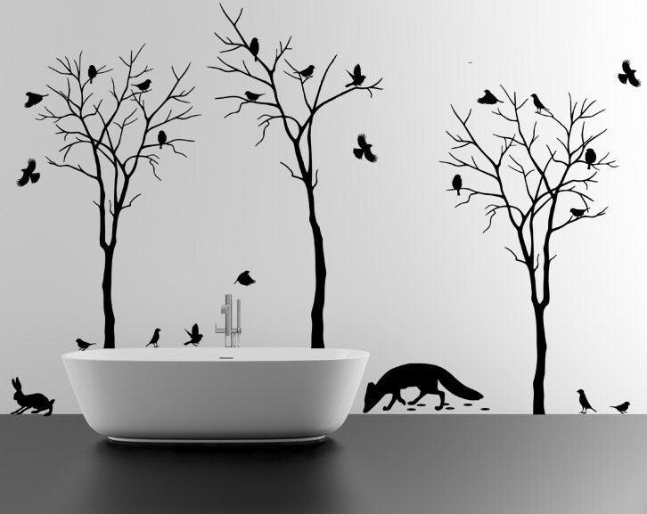 Modern bathroom with black tree wall decals and cute animal silhouettes, creating a serene nature-inspired atmosphere.