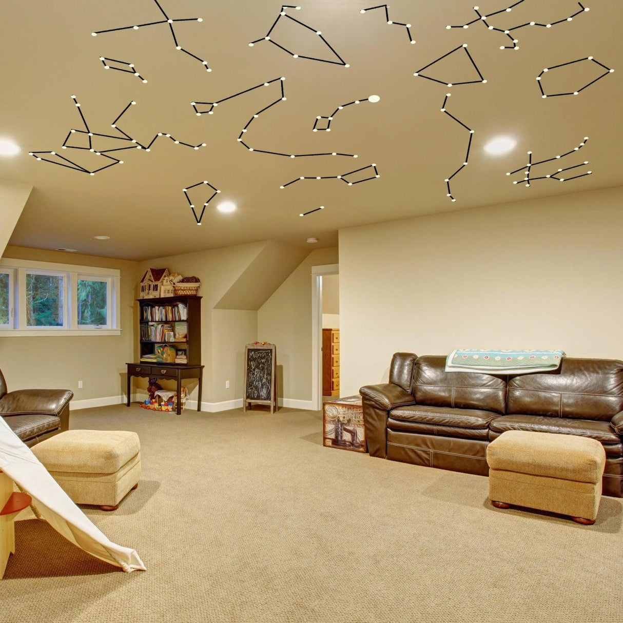 Glowing vinyl ceiling decal star map view in cozy room with constellations and furniture.