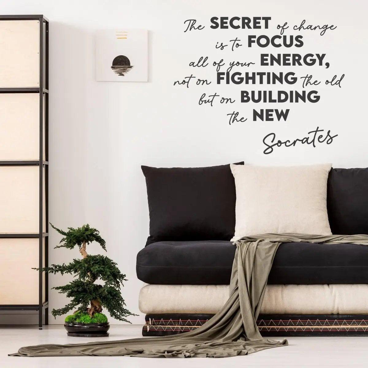 Inspirational vinyl decal quote on wall above a stylish sofa, promoting positivity and change during lockdown.