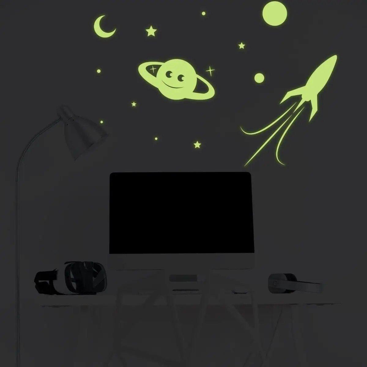 Glow in the dark star wall stickers featuring a smiling planet, stars, and a rocket, perfect for cosmic room decor.