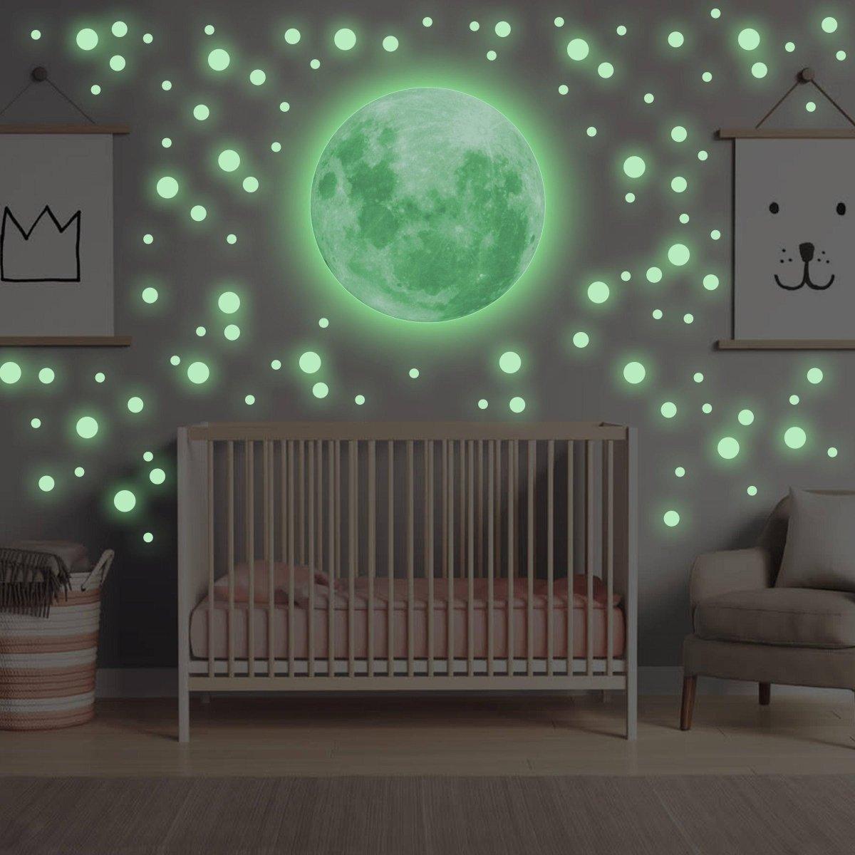 Luminous night sky wall decal featuring a glowing moon and stars in a cozy nursery.