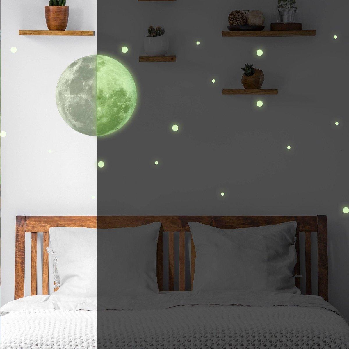 Glowing celestial night sky wall decal with full moon and luminous stars in a child's bedroom.