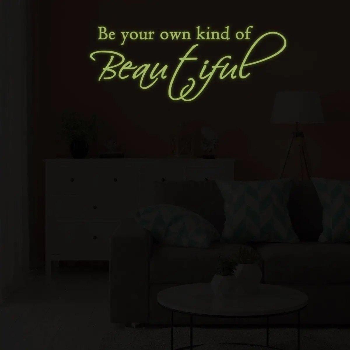 Glowing wall sticker quote 'Be your own kind of Beautiful' in a cozy living room setting.