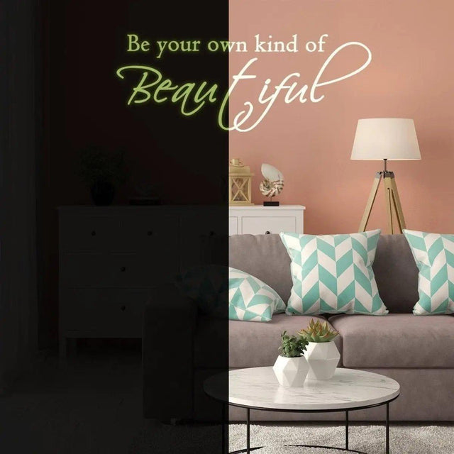 Glowing wall sticker with the quote 'Be your own kind of Beautiful' in a stylish living room setting.
