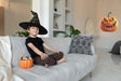 Large pumpkin wall decal displayed in a furnished Halloween room setting.