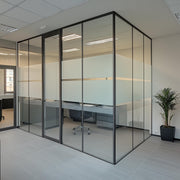 Modern office with glass partitions featuring frosted sections for privacy and natural light.